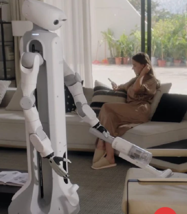 H1 robot arm working alongside a robot vacuum in a living room